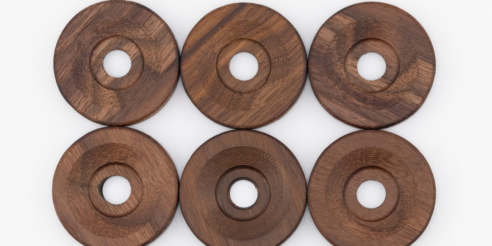 Wide view of solid walnut side fairing washers showing the grain